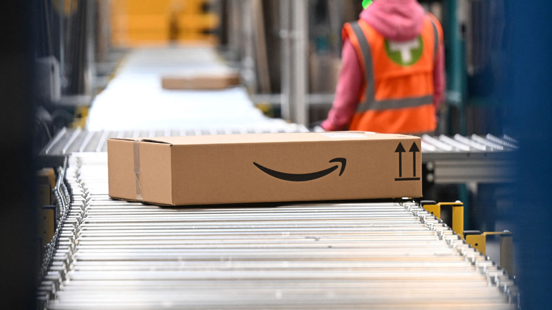 A package with the logo of Amazon is transported along a conveyor belt at a packing station of a redistribution centre of US online retail giant Amazon in Werne, western Germany