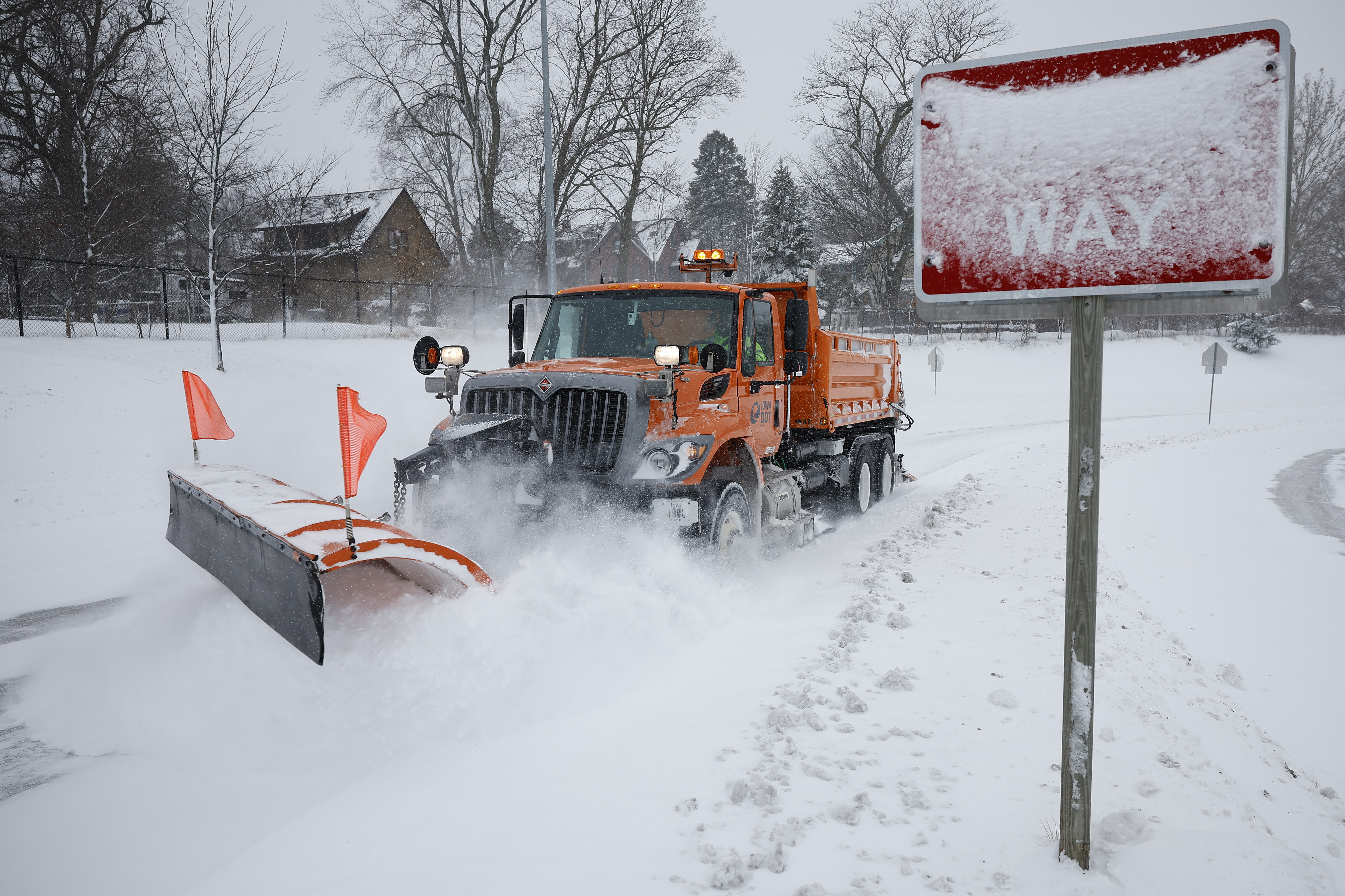 Freeway snowplow truck plowing.